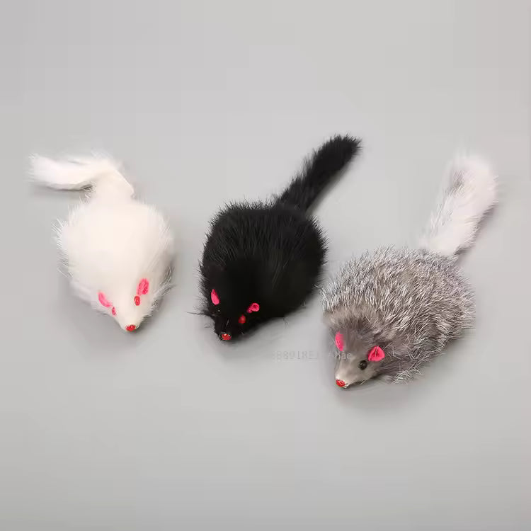 Close-up display of three realistic false cat mouse toys in black, grey, and white, made with soft real rabbit fur for hunting and chasing.