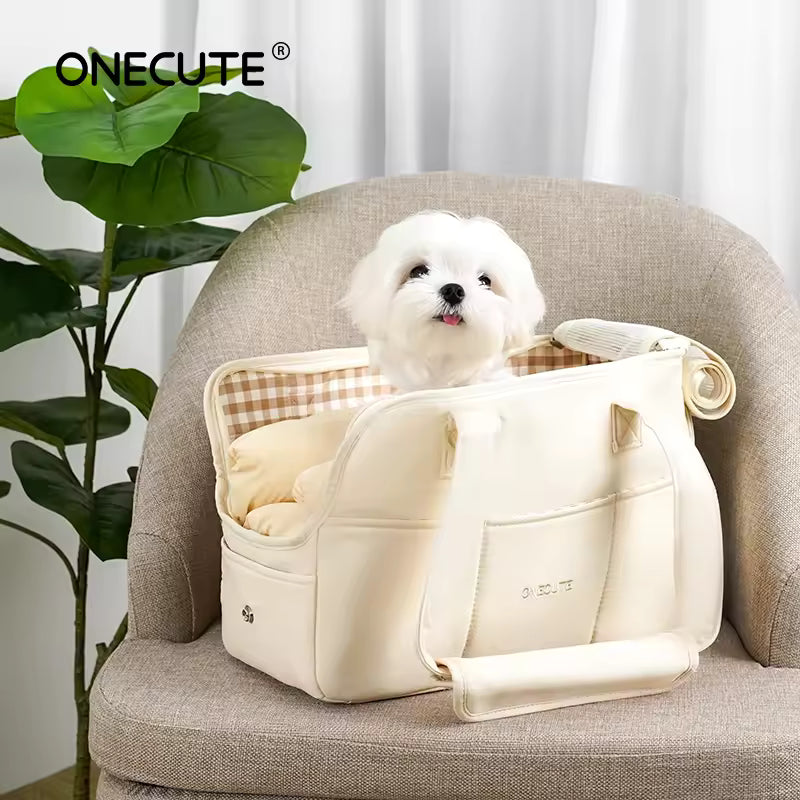Light gray portable dog carrier handbag with a small white Maltese-type dog sitting inside, ready for travel.