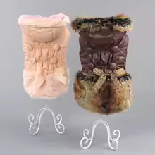 Display of two winter dog coats: one pink and one brown, both featuring quilted puffer fabric and plush faux fur trim.